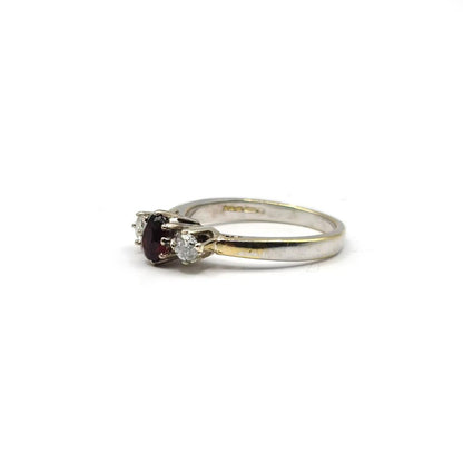 18ct white gold ring featuring 0.24 carat diamonds and 0.45 carat garnet gemstone, elegant jewelry piece with fine detailing.