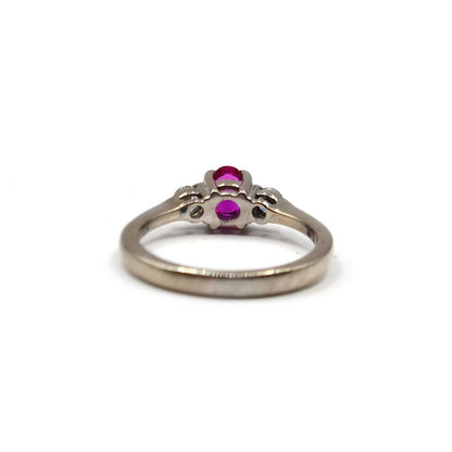 18ct white gold ring featuring a 0.55 carat ruby and 0.20 carat diamonds, elegant jewelry with a polished finish.