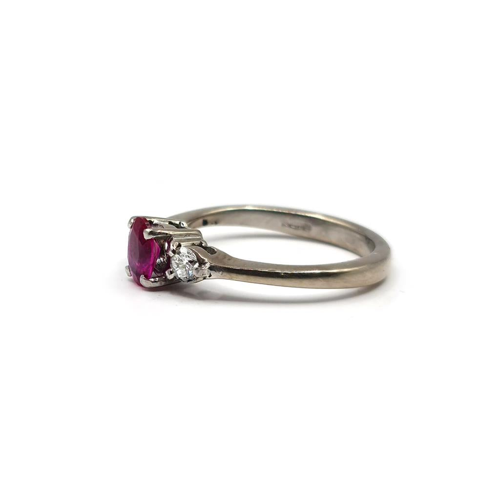 18ct white gold ring featuring a 0.55 carat ruby and 0.20 carat diamonds, elegant jewelry piece with intricate design.