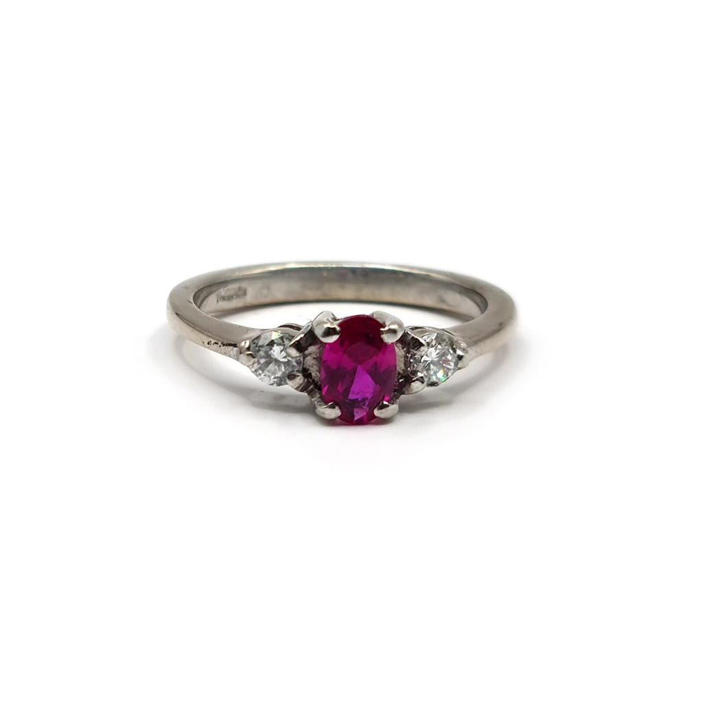 18ct white gold ring with a 0.55 carat ruby and 0.20 carat diamond accents, featuring a elegant and classic design.