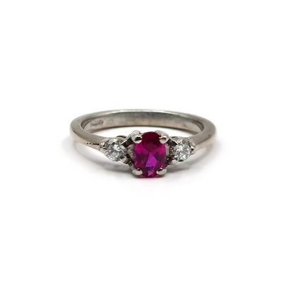18ct white gold ring with a 0.55 carat ruby and 0.20 carat diamond accents, featuring a elegant and classic design.