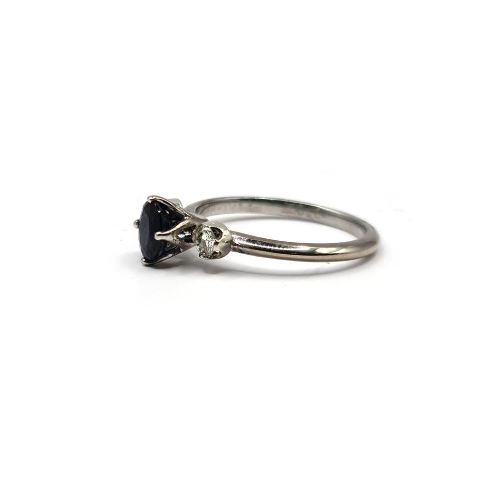 18ct white gold sapphire ring featuring a 0.70 carat central sapphire and smaller 0.30 carat sapphires on a sleek band.
