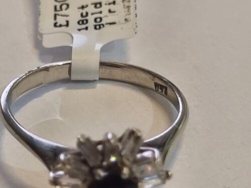 18ct white gold diamond cluster ring with 0.81 carats of sparkling diamonds, showcasing an elegant and intricate design.