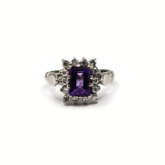 18ct white gold ring with a 1.05 carat emerald cut amethyst and 0.30 carat diamond accents, elegant jewelry design.