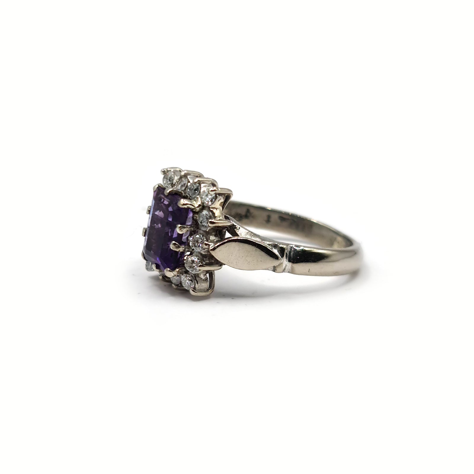 18ct white gold ring with 1.05ct emerald cut amethyst and 0.30ct diamonds, showcasing a elegant gemstone design.