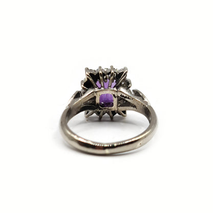 18ct white gold ring featuring a 1.05 carat emerald cut amethyst and 0.30 carat diamond accents.