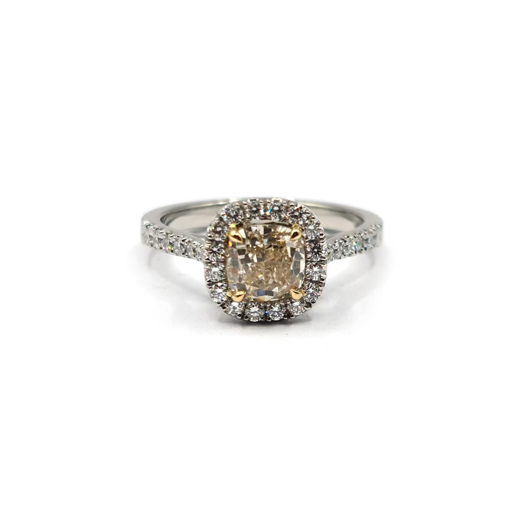 18ct white gold ring with a 1.15ct fancy yellow diamond and 0.60ct diamond halo, featuring VS1 clarity.