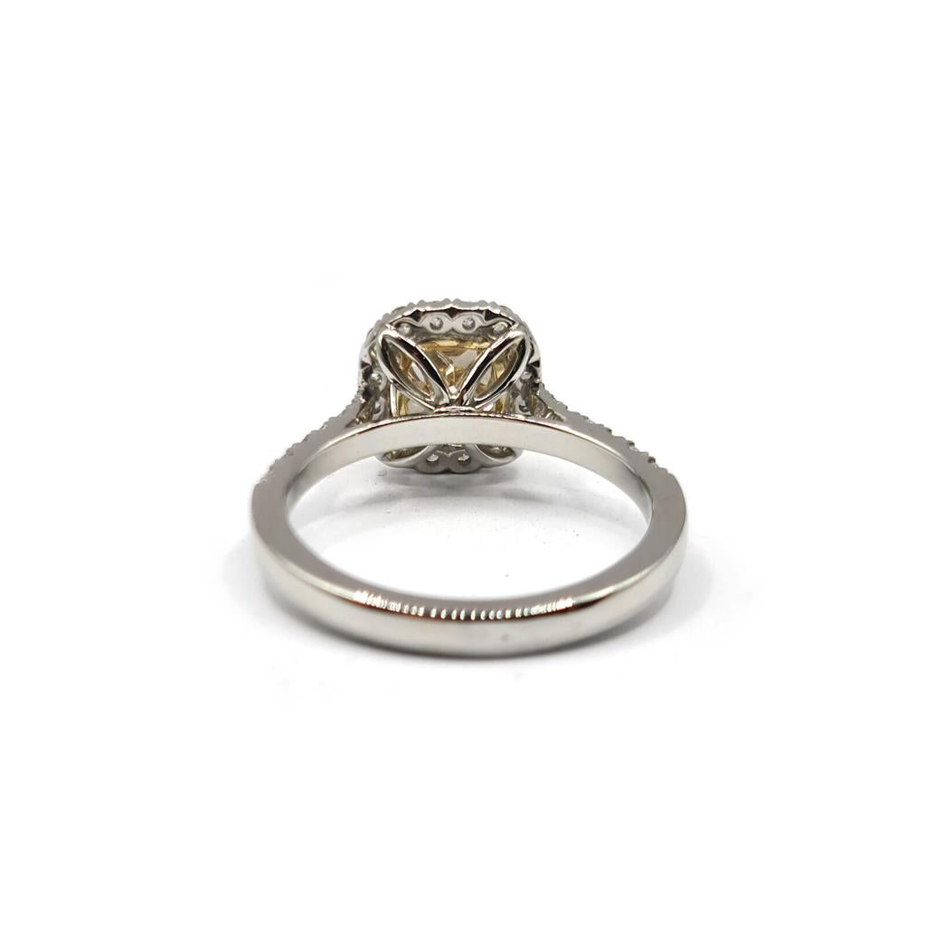 18ct white gold ring featuring a 1.15 carat fancy yellow diamond and 0.60 carat diamond halo with VS1 clarity.