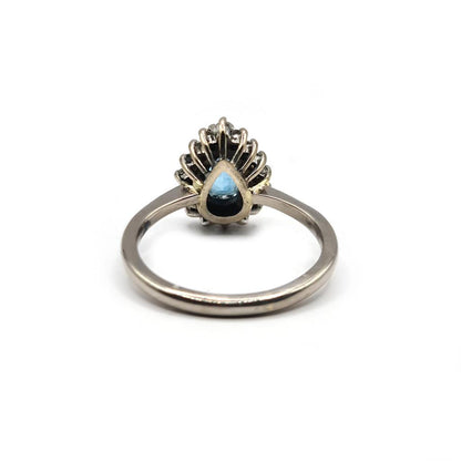 18ct white gold ring with a 1.90ct pear-shaped topaz and 0.40ct diamond accent, elegant jewelry piece.