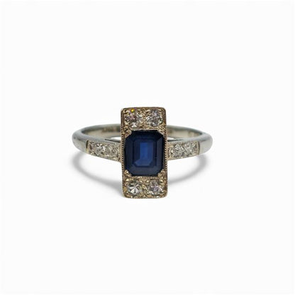 18ct white gold and platinum ring with diamonds and sapphires, featuring a detailed design and sparkling gemstones.