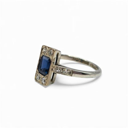 18ct white gold ring with diamonds and sapphires, featuring a sleek design and sparkling gemstone accents.