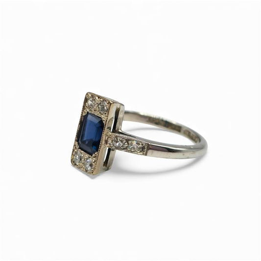 18ct white gold ring with diamonds and sapphires, featuring a sleek design and sparkling gemstone accents.