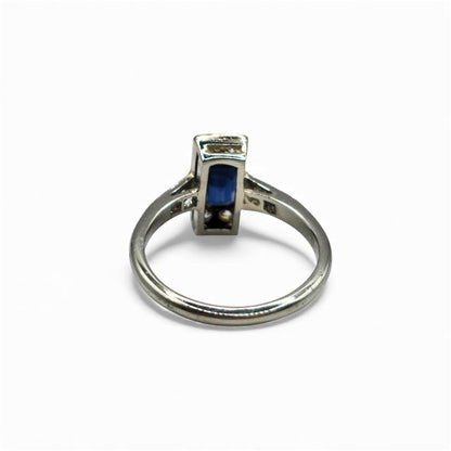 18ct white gold and platinum ring with diamonds and sapphires, showcasing a detailed design and sparkling gemstones.
