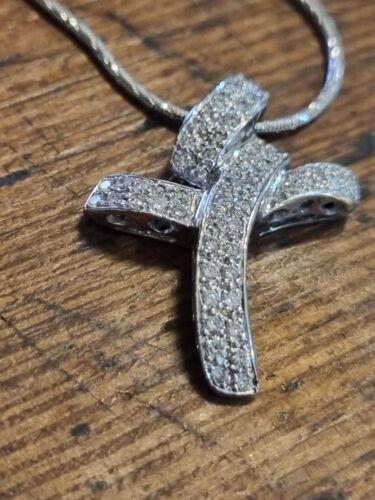 18ct white gold chain with 0.65 carat diamond twist design cross, showcasing elegant jewelry craftsmanship.