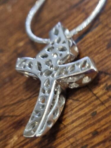18ct white gold chain with 0.65 carat diamond twist design cross, featuring a delicate, elegant jewelry piece.