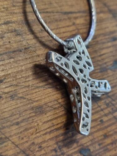 18ct white gold chain with a 0.65 carat diamond twist cross pendant, showcasing elegant jewelry craftsmanship.