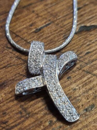 18ct white gold chain with 0.65 carat diamond twist cross, featuring elegant design and sparkling gemstones.