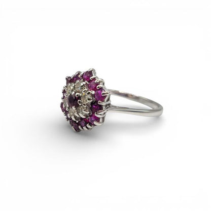 18ct white gold diamond and ruby ring with a central ruby and sparkling diamonds, elegant jewelry accessory.