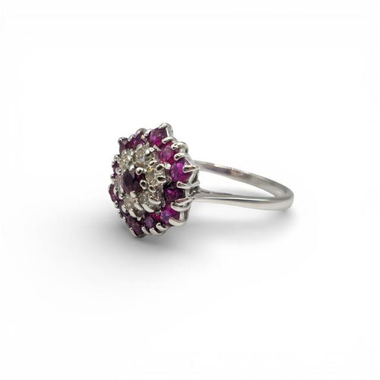 18ct white gold diamond and ruby ring with a central ruby and sparkling diamonds, elegant jewelry accessory.