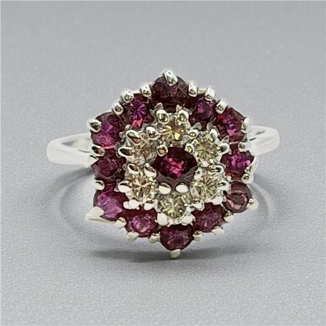 18ct white gold diamond and ruby ring with a central gemstone, elegant and sparkling jewelry piece.