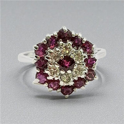 18ct white gold diamond and ruby ring with a central gemstone, elegant and sparkling jewelry piece.