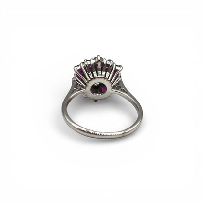 18ct white gold diamond and ruby ring with a central ruby and sparkling diamonds, elegant unbranded jewelry design.