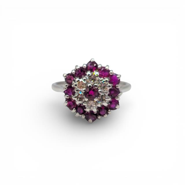 18ct white gold diamond and ruby ring with a central ruby and sparkling diamonds, elegant jewelry piece.