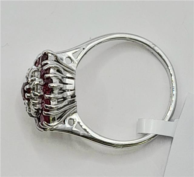 18ct white gold diamond and ruby ring with intricate design, showcasing sparkling diamonds and vibrant rubies.