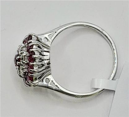 18ct white gold diamond and ruby ring with intricate design, showcasing sparkling diamonds and vibrant rubies.