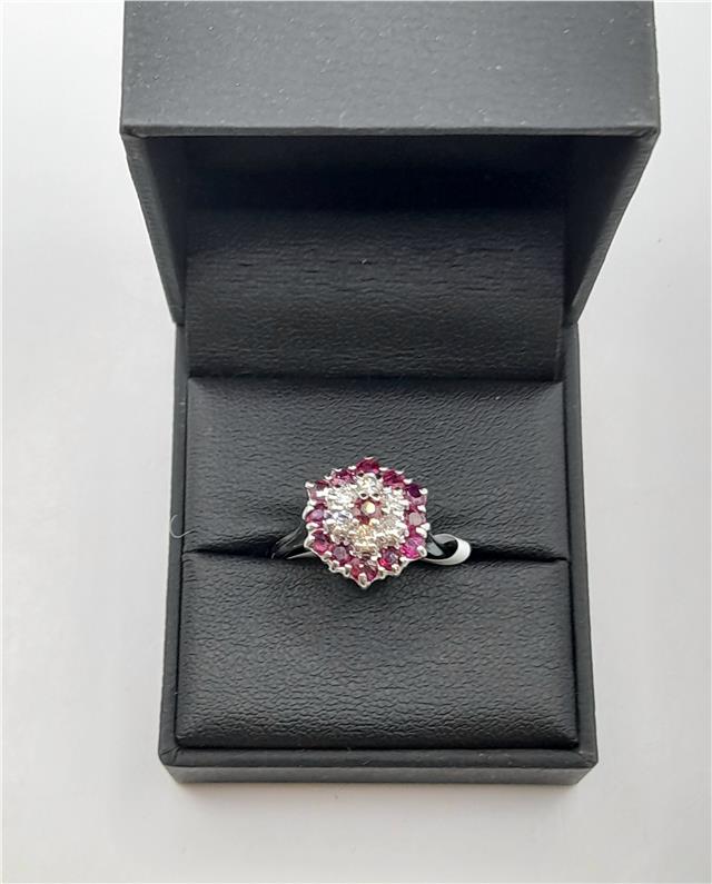 18ct white gold ring featuring diamonds and rubies, showcasing a elegant design with sparkling gemstones.