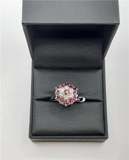 18ct white gold ring featuring diamonds and rubies, showcasing a elegant design with sparkling gemstones.