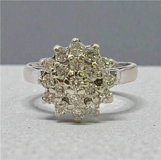 18ct white gold diamond cluster ring in size L featuring a sparkling diamond design, unbranded jewelry piece.