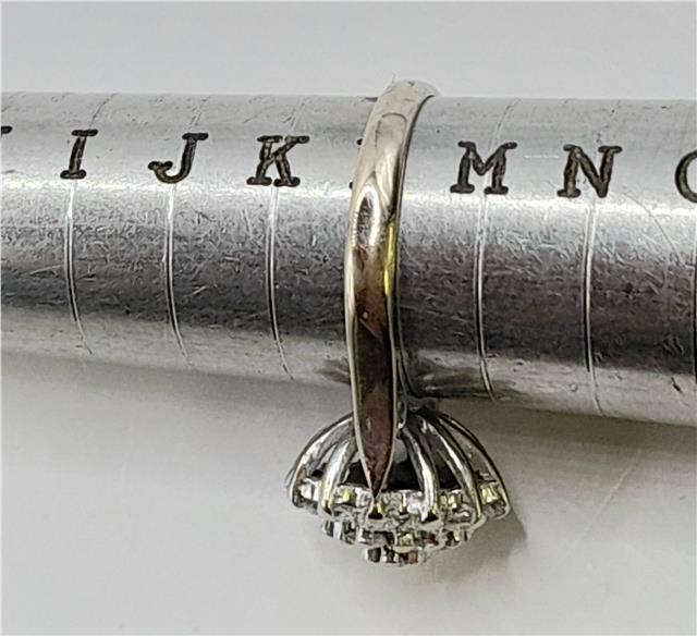 18ct white gold diamond cluster ring in size L with sparkling diamond details, elegant jewelry piece.