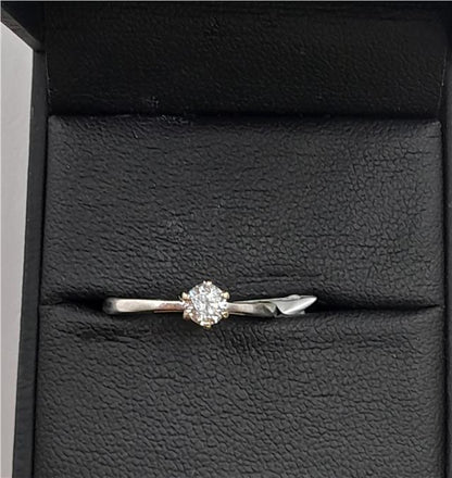 18ct white gold diamond ring in size I 1/2 featuring sparkling diamonds on a sleek band.
