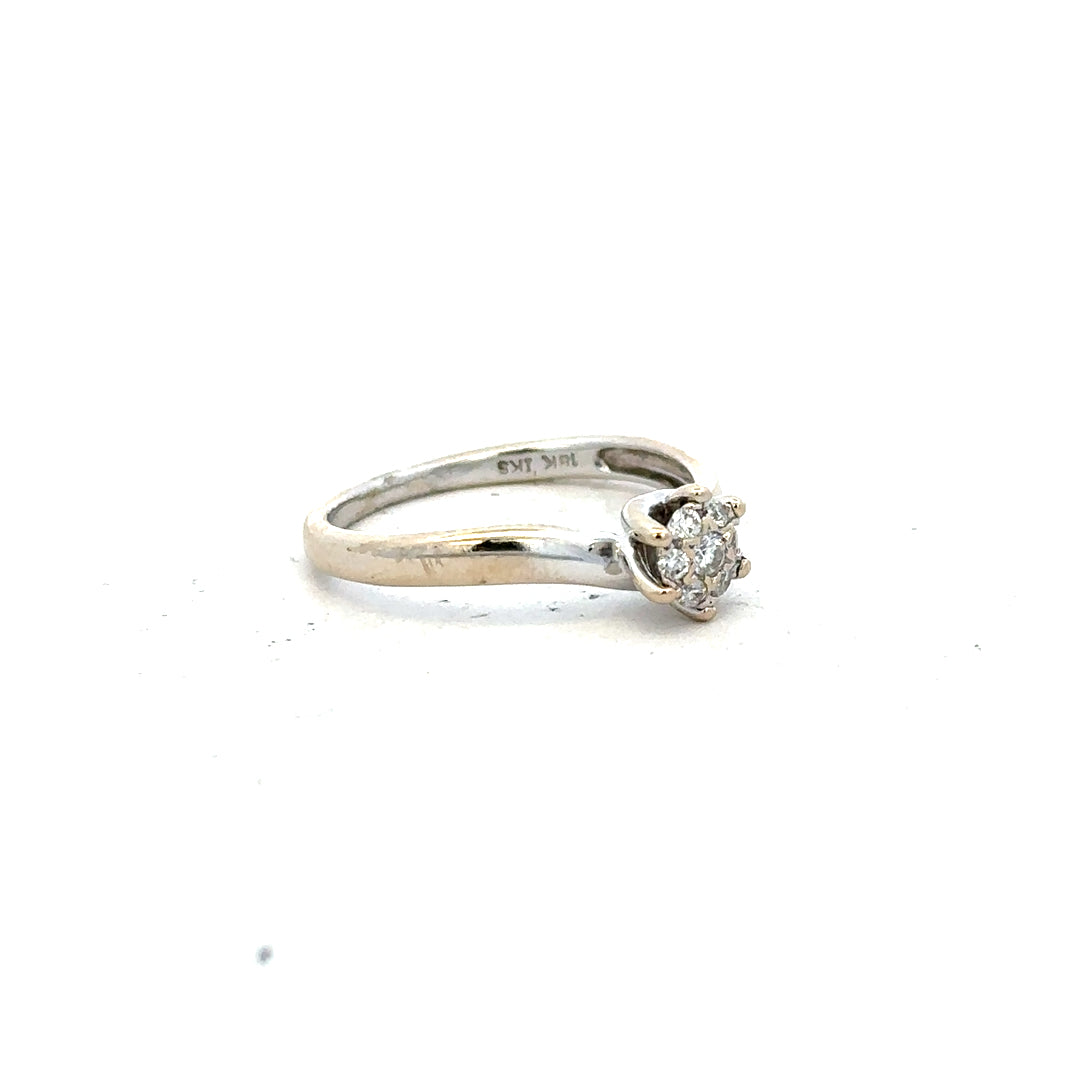18ct white gold diamond ring in size N, featuring a sparkling central diamond and intricate band design.