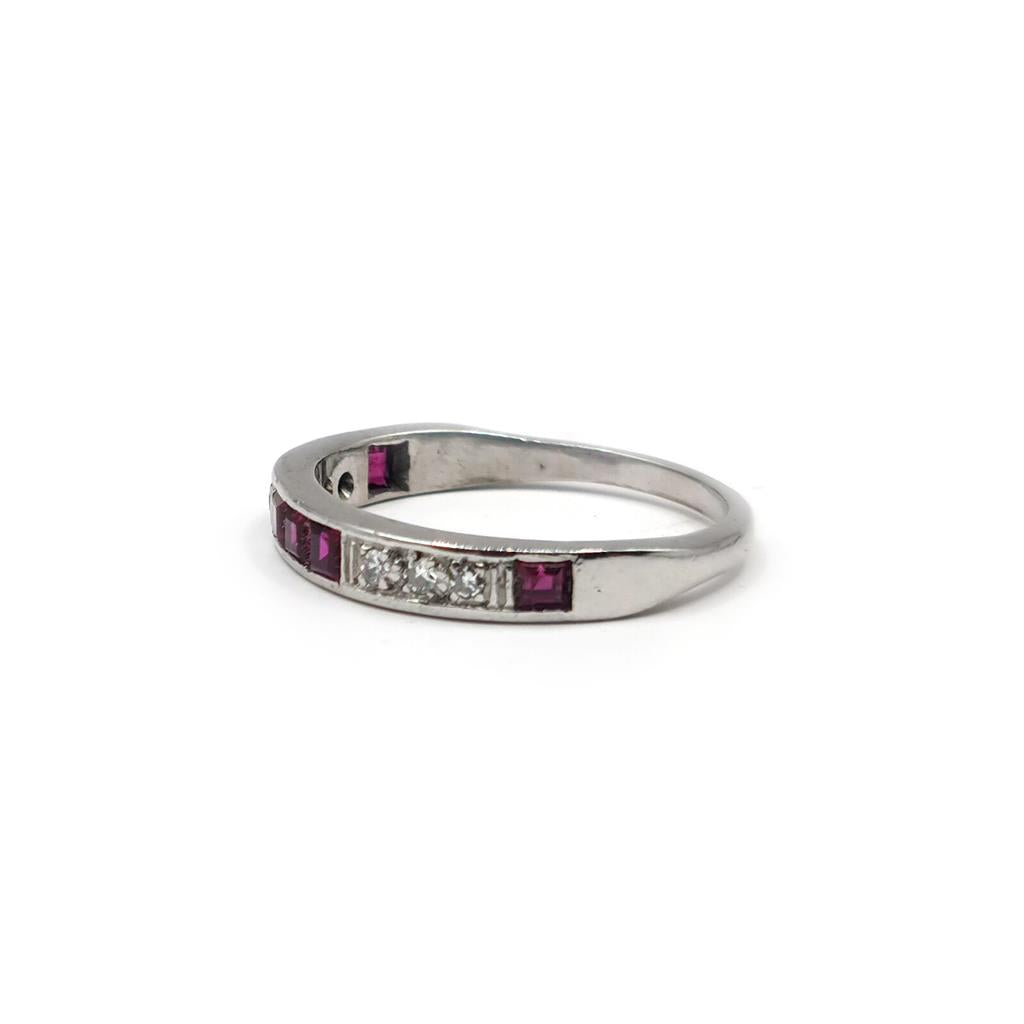 18ct white gold ruby and diamond half eternity ring, showcasing sparkling gemstones set in a sleek band.