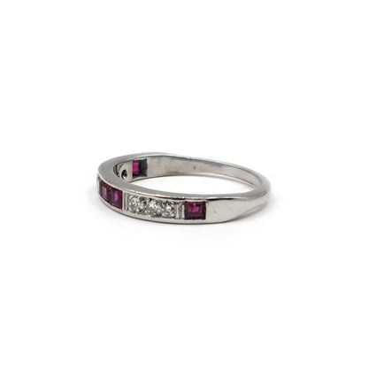 18ct white gold ruby and diamond half eternity ring with alternating gemstones and a sleek, elegant design.