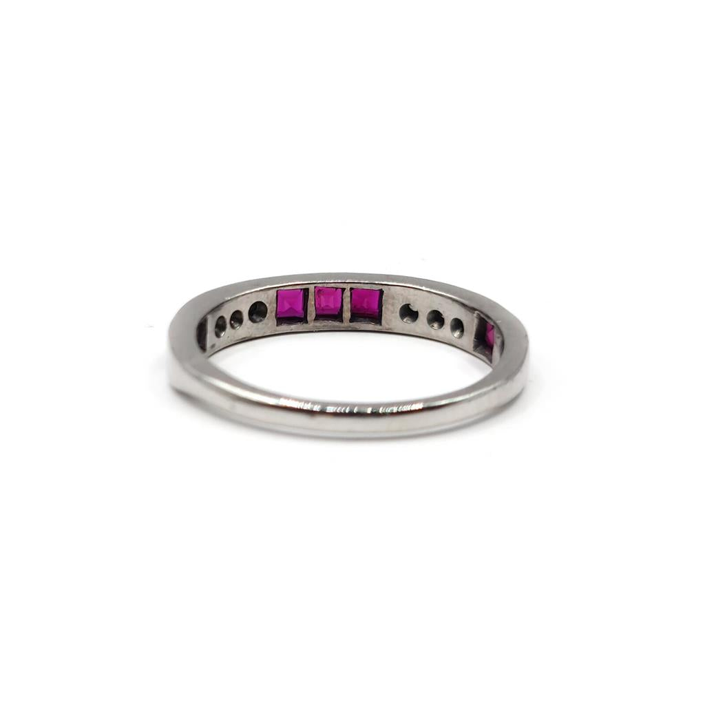 18ct white gold ruby and diamond half eternity ring with alternating gemstones and delicate band design.