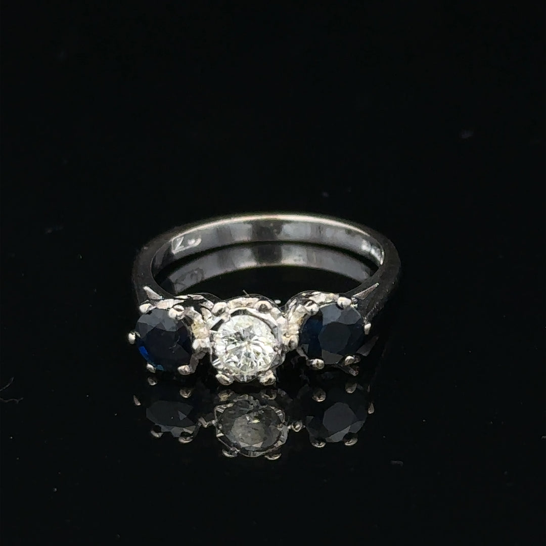 18ct white gold sapphire and diamond ring with a central blue sapphire and sparkling diamonds, elegant jewelry for special occasions