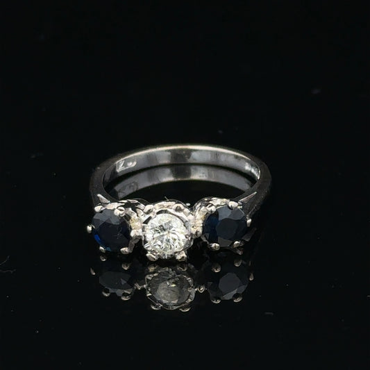 18ct white gold sapphire and diamond ring with a central blue sapphire and sparkling diamonds, elegant jewelry for special occasions