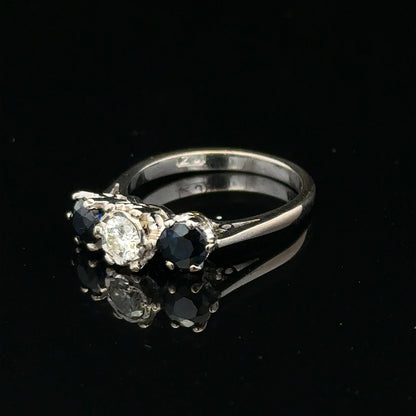 18ct white gold sapphire and diamond ring showcasing a central blue sapphire surrounded by sparkling diamonds.