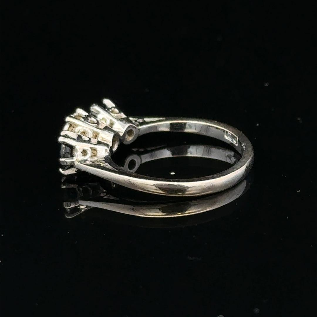 18ct white gold sapphire and diamond ring featuring a central blue sapphire surrounded by sparkling diamonds.
