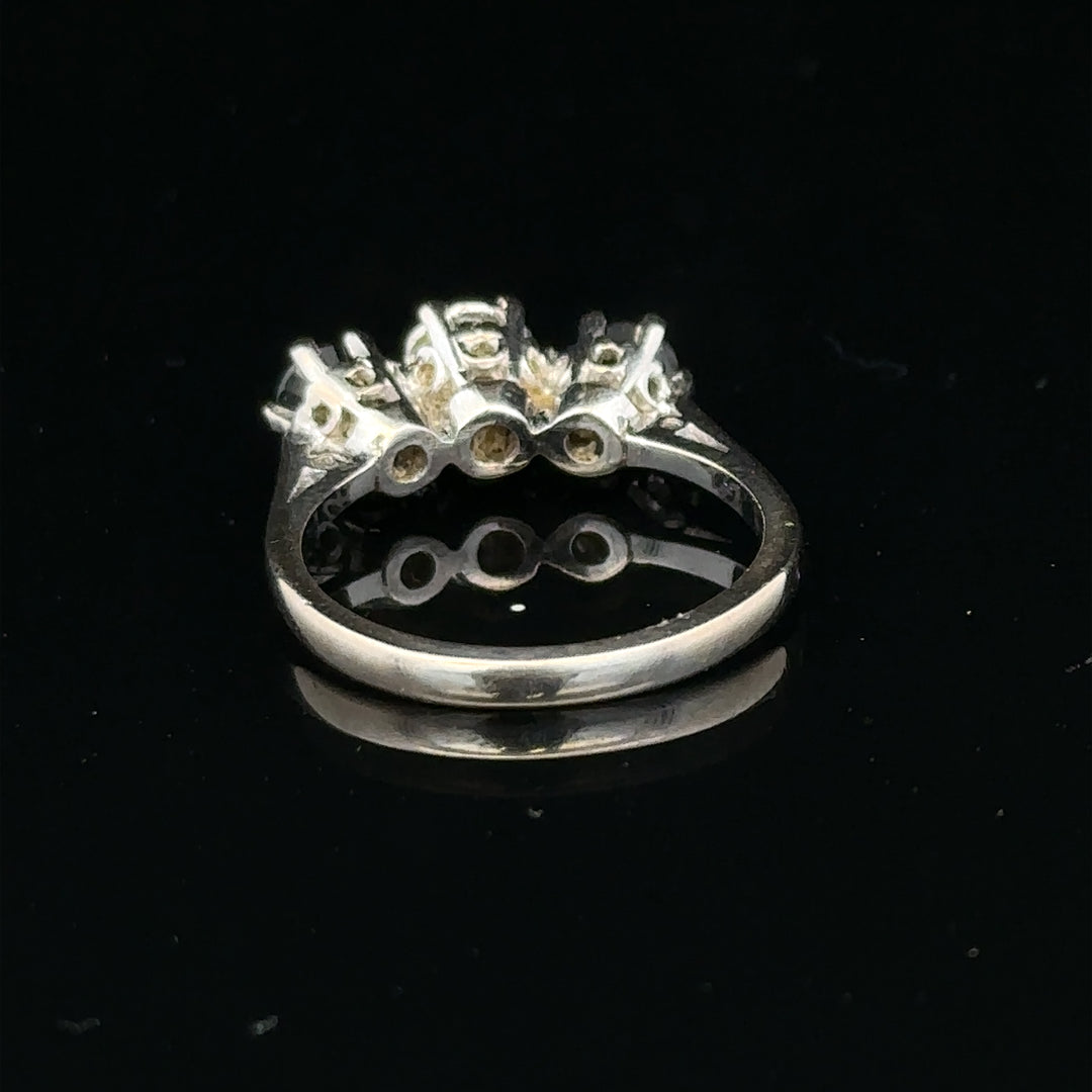 18ct white gold sapphire and diamond ring with a central sapphire and surrounding diamonds, elegant jewelry design.