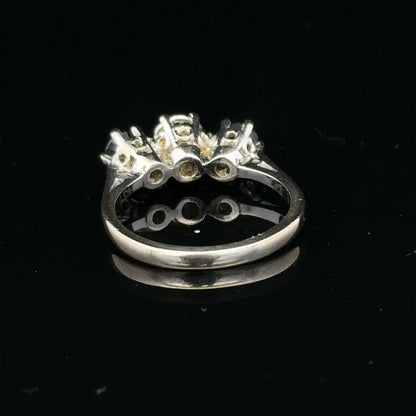 18ct white gold sapphire and diamond ring with a central sapphire and surrounding diamonds, elegant jewelry design.