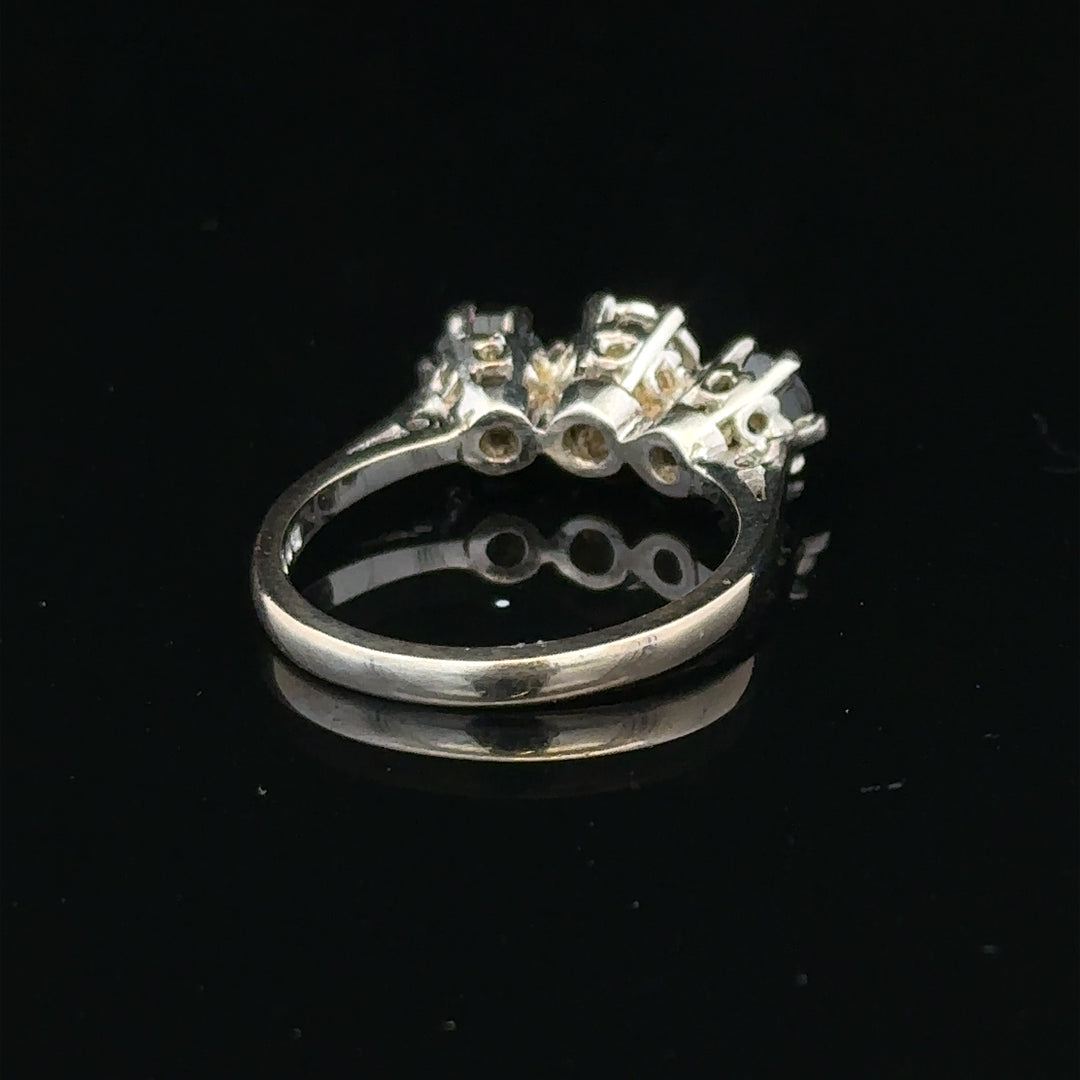 18ct white gold ring with a central sapphire and diamond accents, showcasing elegant jewelry design.