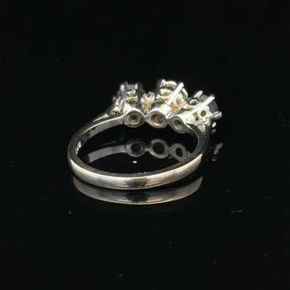 18ct white gold ring with a central sapphire and diamond accents, showcasing elegant jewelry design.