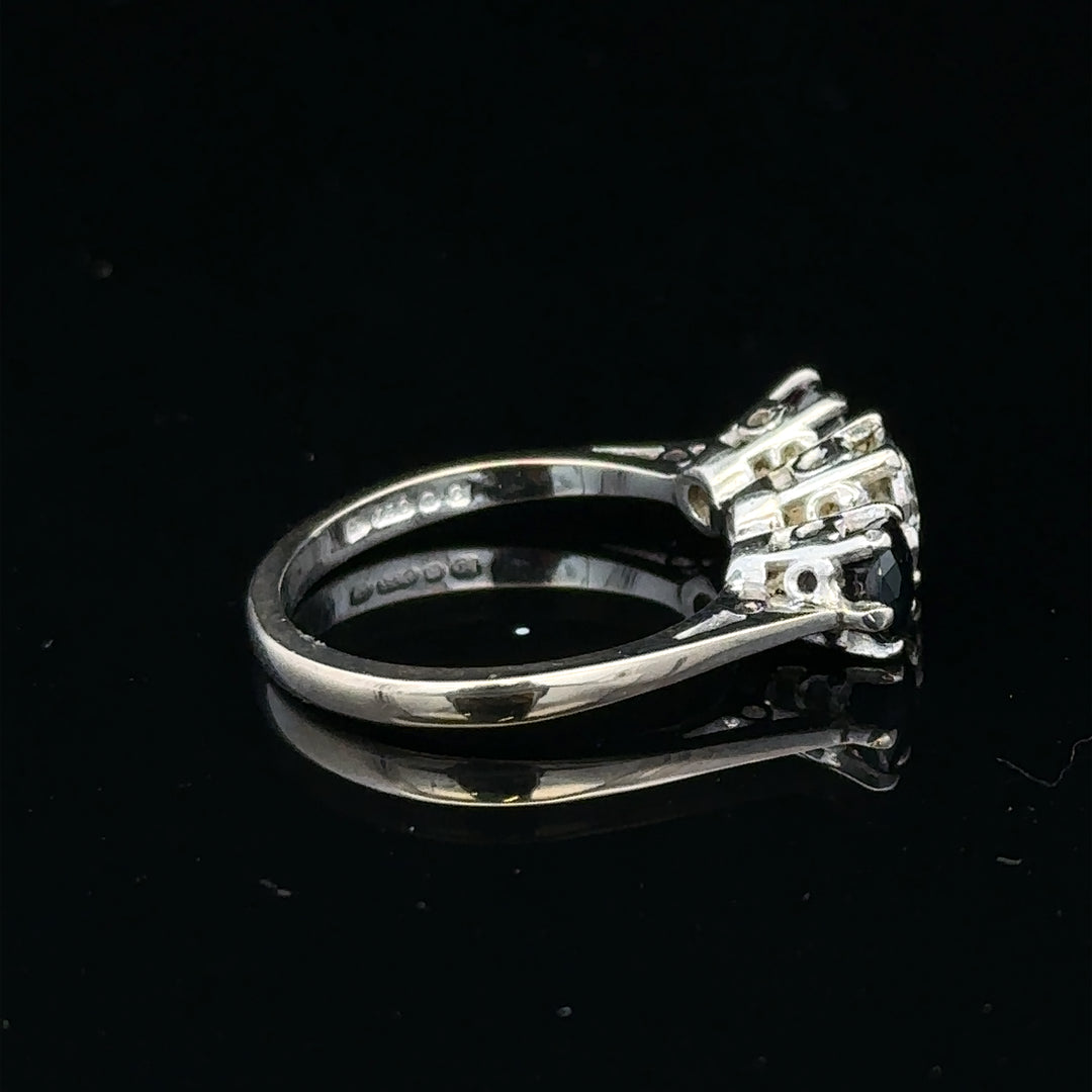 18ct white gold sapphire and diamond ring with a central blue sapphire and sparkling diamonds, elegant jewelry accessory