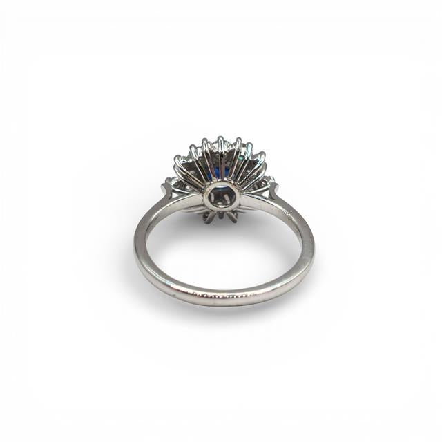 18ct white gold sapphire and diamond ring with a central blue sapphire and surrounding diamonds, elegant jewelry design.