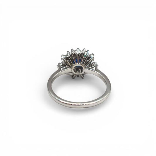 18ct white gold sapphire and diamond ring with a central blue sapphire and surrounding diamonds, elegant jewelry design.
