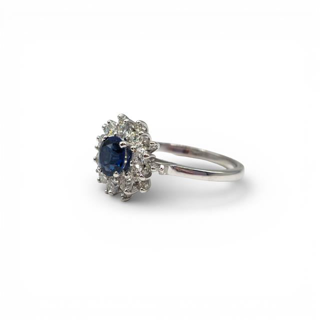 18ct white gold sapphire and diamond ring with intricate detailing, showcasing a stunning central sapphire gemstone.